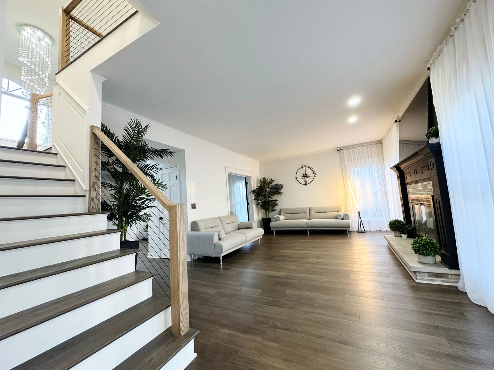 Stairs after, with white risers, wood treads and a new railing