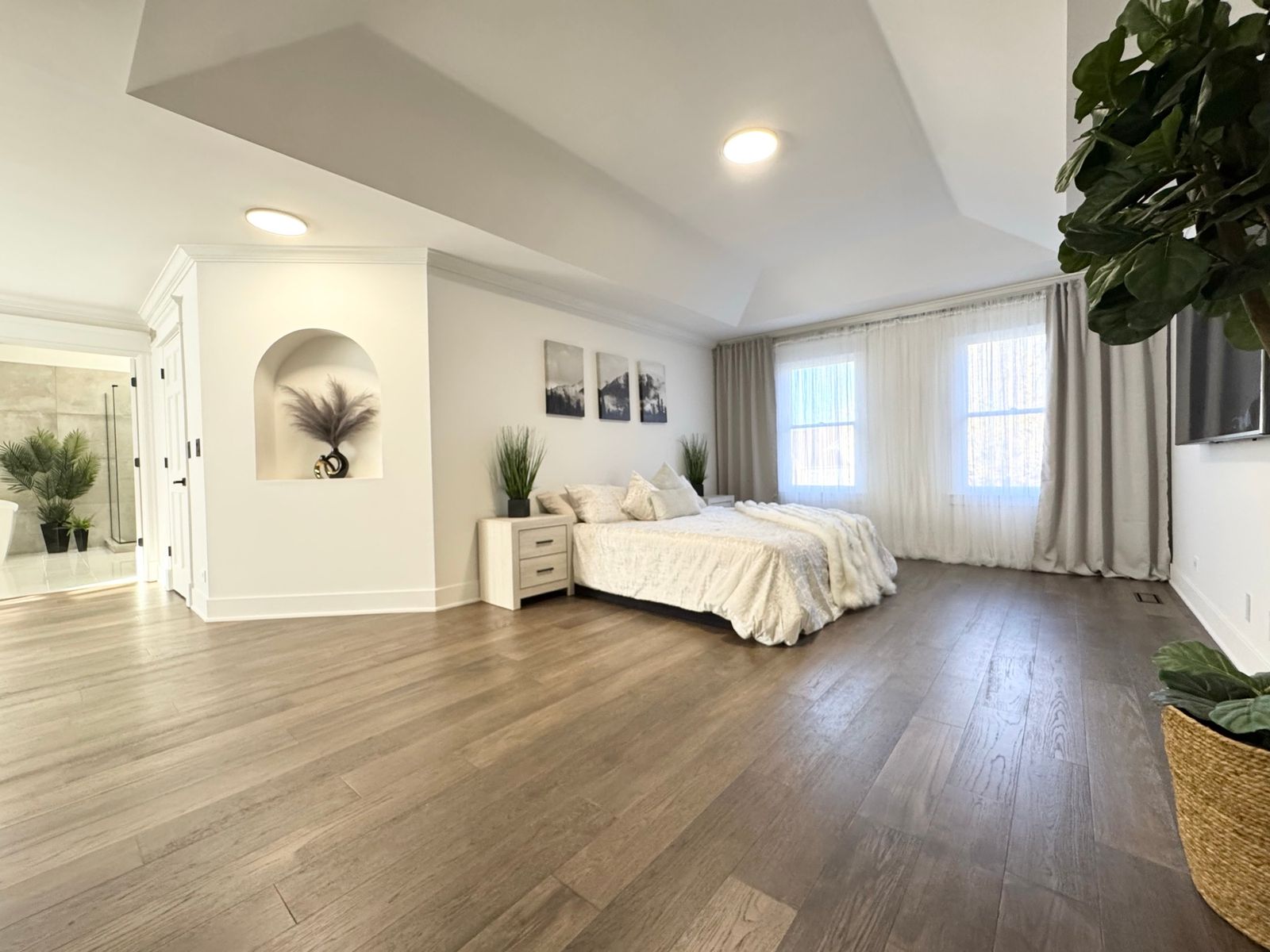 Bedroom after, with a new plank floor and light walls